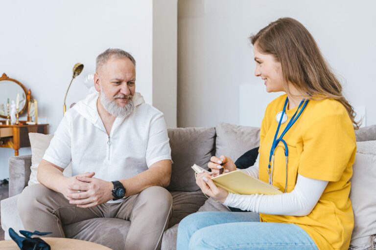 Professionnelle de santé en consultation avec un homme âgé